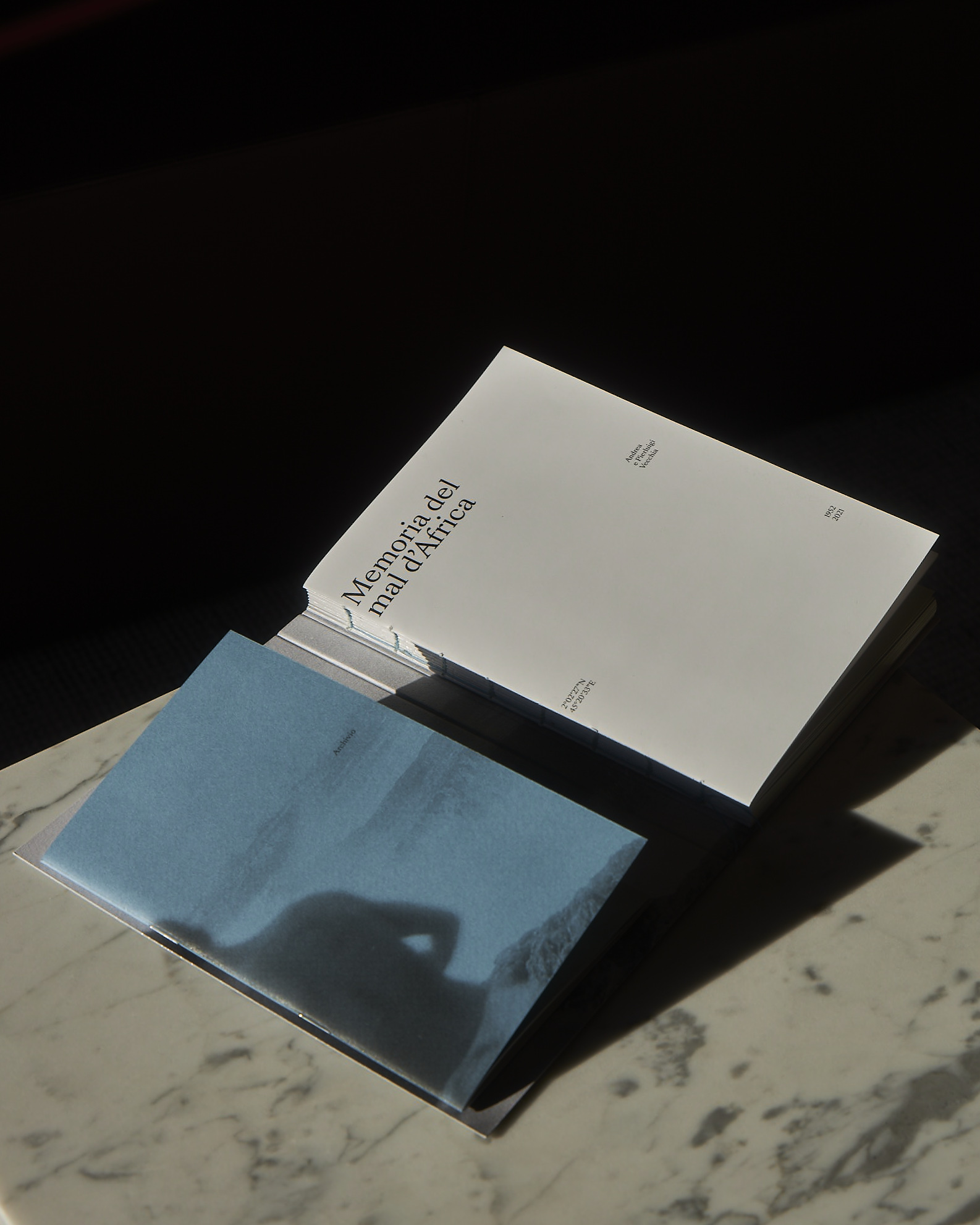 Memorie del Mal D'Africa book open at the first page on a marble table top