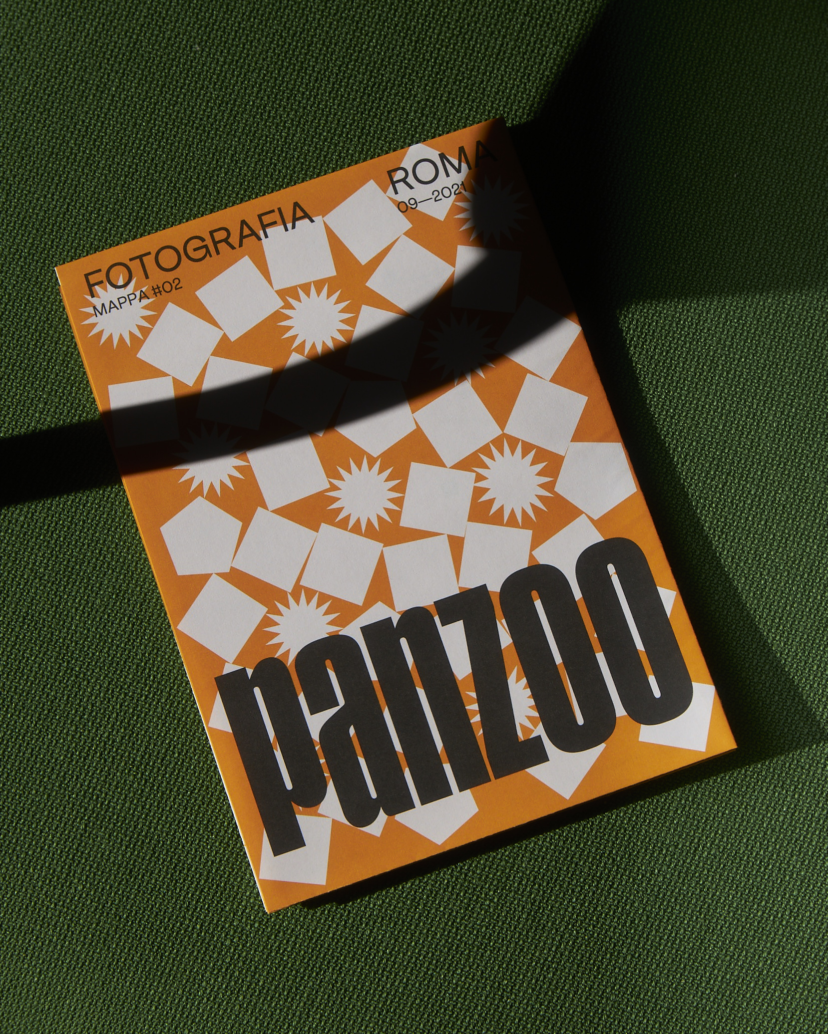 Panzoo flyer laying on a green textile surface